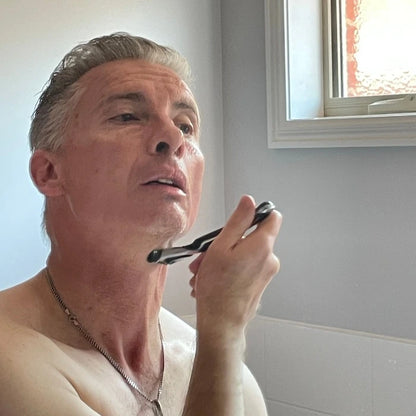 Shaving cream.Man applying shaving cream to face.